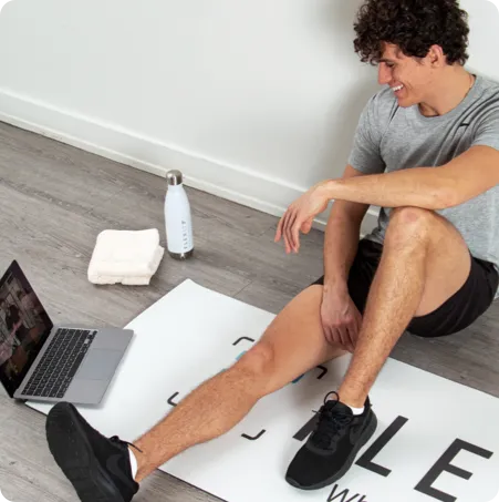 guy talking to his trainer on a laptop