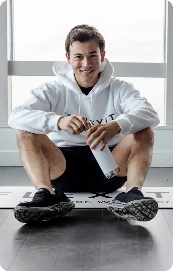 man sitting with a water bottle in hand